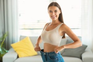 Woman in jeans that are too big to show slim body from Coolsculpting in Scarsdale
