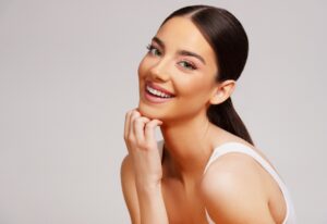 Woman smiling with clear, healthy skin after laser skin resurfacing in Scarsdale, NY